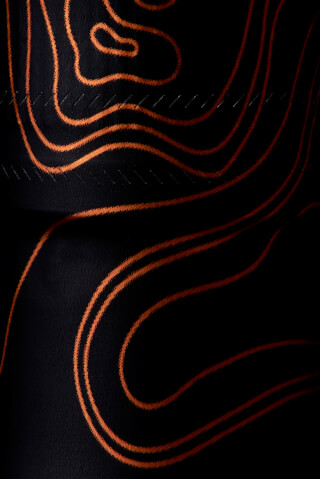 Abstract pattern with black background and orange topographic lines. Great for modern backgrounds.