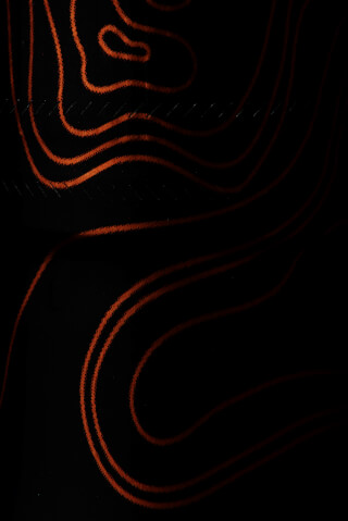 Abstract design with curved orange lines on a black background, creating a modern and minimalist aesthetic.