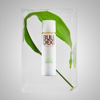 Studio shot of Bulldog Original shave gel with a leaf, for skincare and grooming.