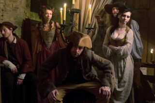 A group of pirates in a dimly lit tavern scene, captured with vintage style lighting and composition.