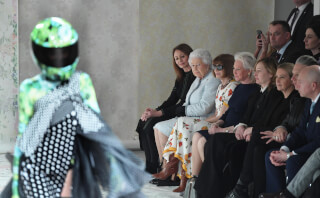 Queen Elizabeth II attends a fashion show during fashion week.