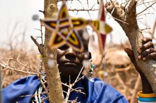 Portrait of a Maasai man in traditional attire, showcasing vibrant jewelry and cultural heritage.