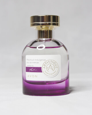 A bottle of Avon Patchouli Indulgence perfume, capturing its elegant design and vibrant colors.