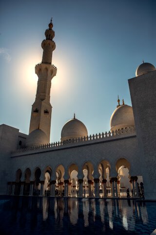 Grand mosque architecture featuring minarets and domes, showcasing islamic design and serene atmosphere.