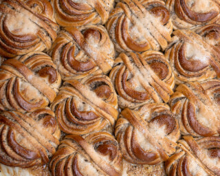 A close-up of freshly baked cinnamon buns, perfect for breakfast or dessert.