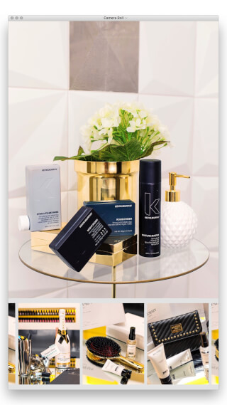Elegant display of Kevin Murphy hair products arranged on a glass table with a golden accent, perfect for beauty or hair care campaigns.