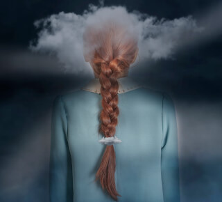 Conceptual image of a woman with a cloud above her head and in her braid.