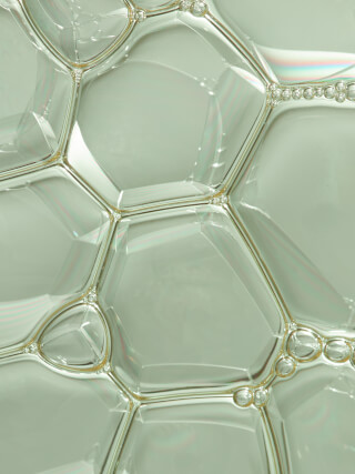 Close-up of soap bubbles forming a soft, textured pattern.