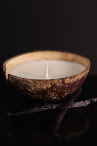 A coconut bowl candle with vanilla beans creates a relaxing, natural home fragrance.
