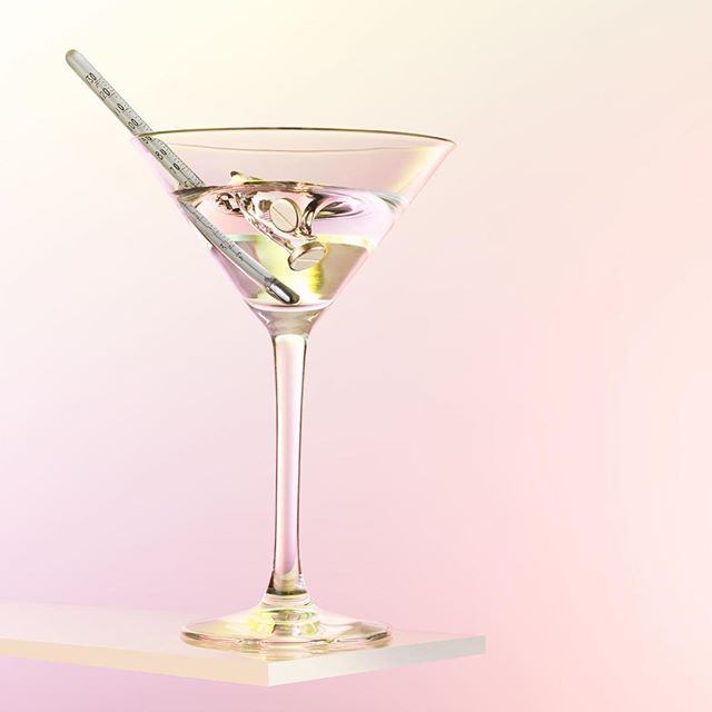 Conceptual image of a martini glass with a thermometer and a pill inside against a light background.